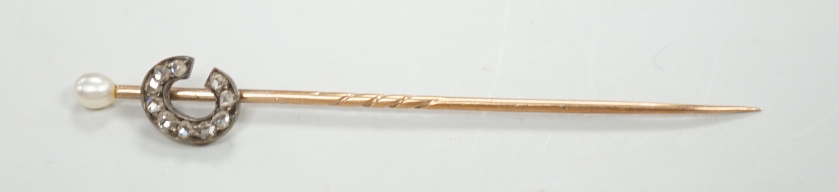 An Edwardian 15ct riding crop brooch(a.f.), 59mm, 2.8 grams, an 18ct hunting horn brooch (lacking pin) 2.1 grams, two Victorian diamond cluster set stick pins including swan in flight, a diamond set pin terminal, gross 4